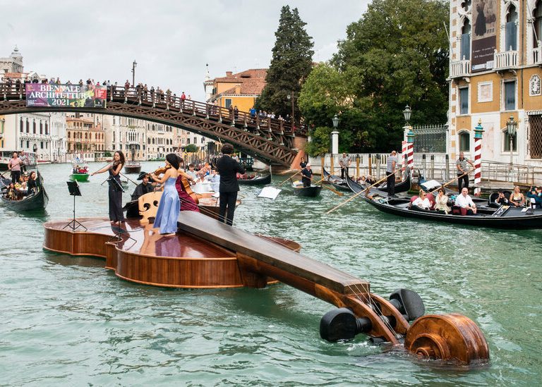 A giant violin floats down venice’s grand canal